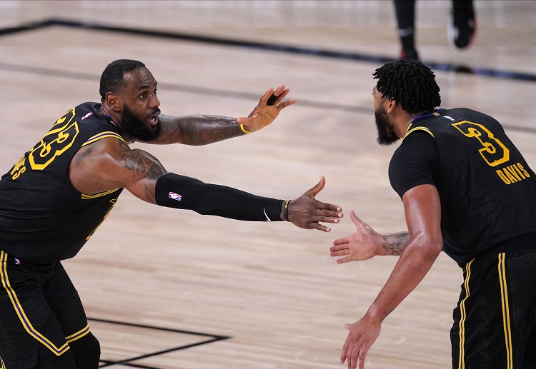 LeBron James celebrates with Anthony Davis after winning Game 2 of their NBA series against the Rockets
