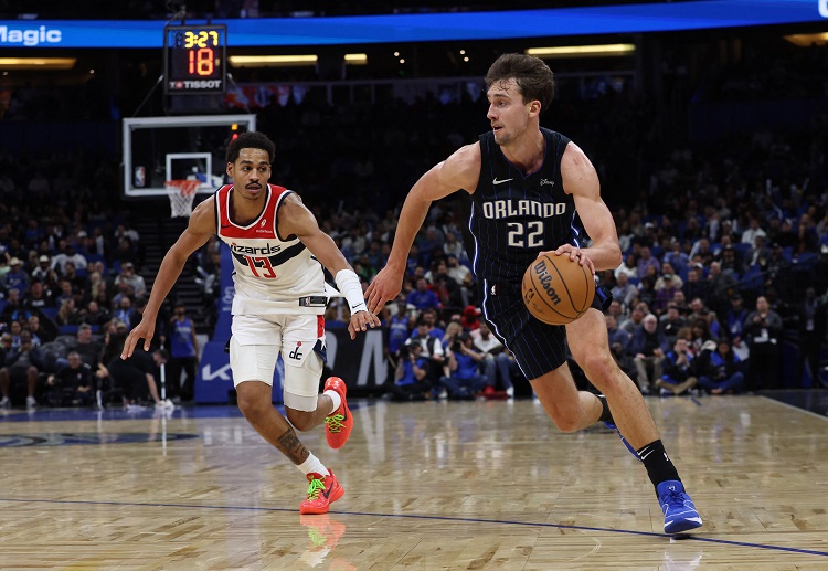 Magic forward Franz Wagner heads to the basket, defended by Wizards guard Jordan Poole in their NBA clash
